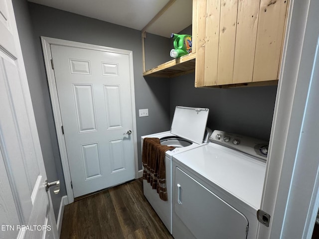 clothes washing area with cabinets, dark hardwood / wood-style flooring, and independent washer and dryer