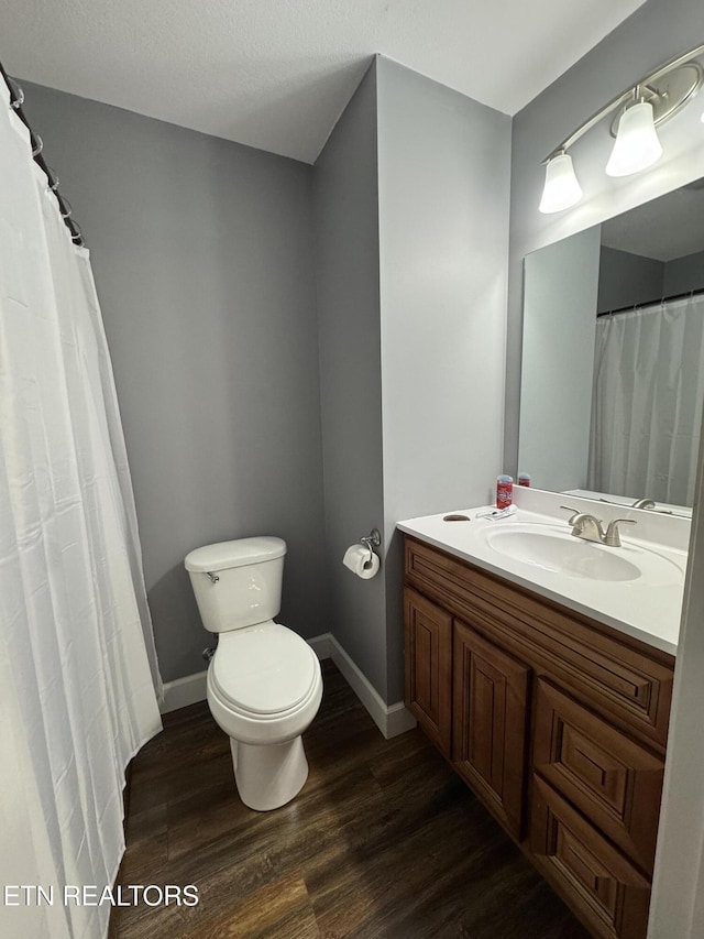 bathroom featuring vanity, hardwood / wood-style floors, and toilet