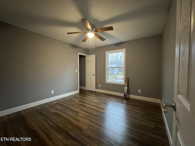 unfurnished room featuring ceiling fan and dark hardwood / wood-style flooring