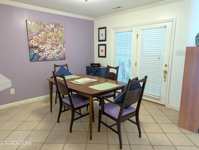 dining space with ornamental molding and light tile patterned floors