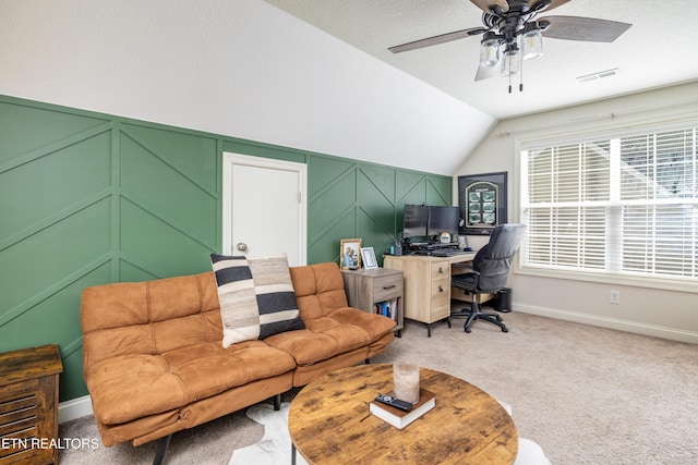 home office with vaulted ceiling, ceiling fan, carpet floors, and a textured ceiling