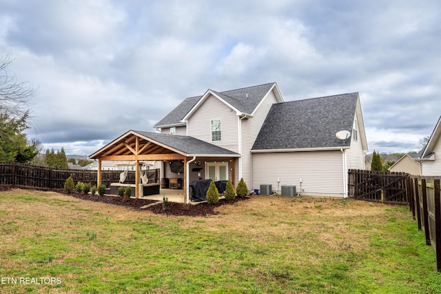 back of property featuring cooling unit, a yard, and a patio