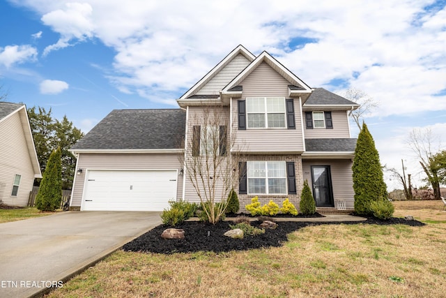 view of front of property with a garage and a front lawn