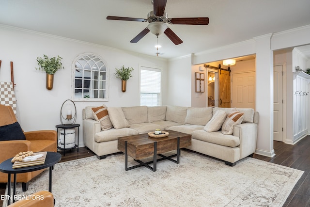 living room featuring hardwood / wood-style flooring, crown molding, a barn door, and ceiling fan