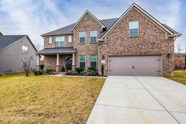 craftsman-style home featuring a garage and a front yard