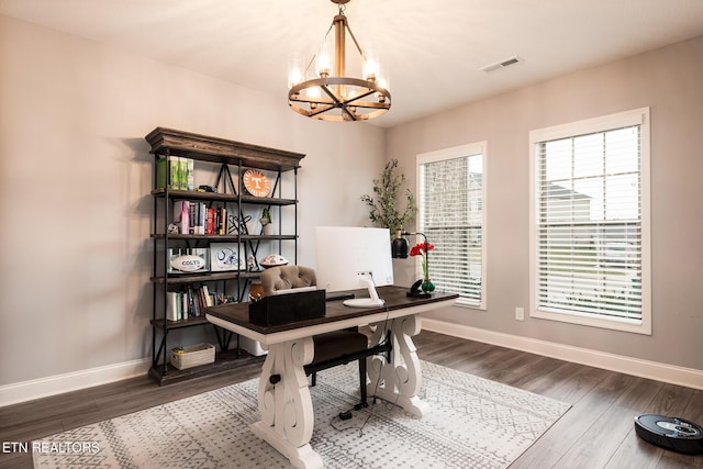 office area with a chandelier and hardwood / wood-style floors