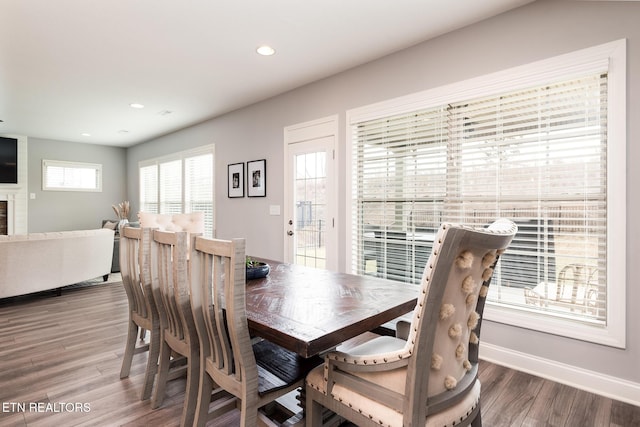 dining area featuring a fireplace and hardwood / wood-style floors