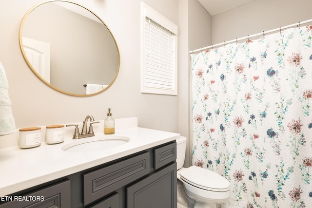 bathroom featuring vanity and toilet