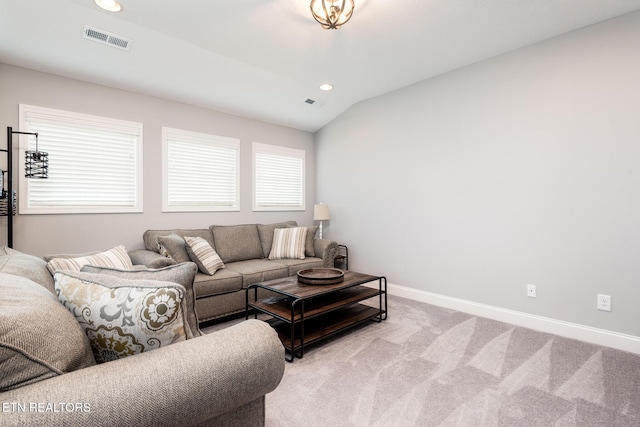 living room featuring light colored carpet and vaulted ceiling