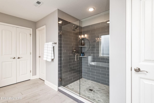 bathroom featuring wood-type flooring and a shower with door