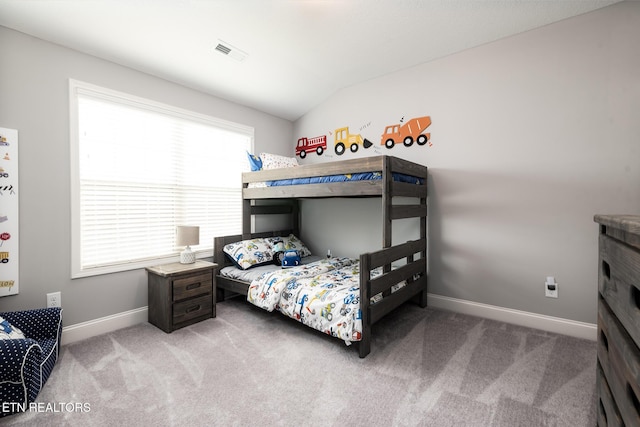 carpeted bedroom featuring vaulted ceiling