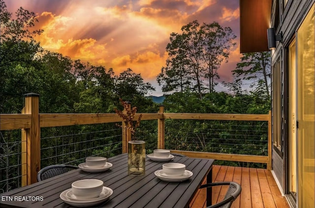 wooden deck with outdoor dining area