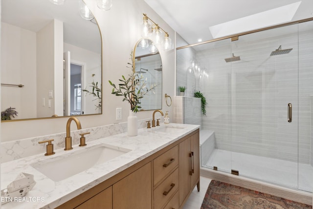 bathroom featuring vanity and a shower with shower door