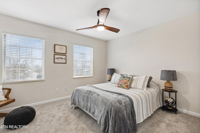 bedroom with ceiling fan and light carpet