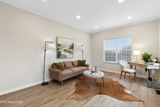 living room with light hardwood / wood-style flooring and ornamental molding