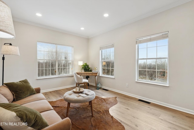 interior space with ornamental molding and light hardwood / wood-style flooring