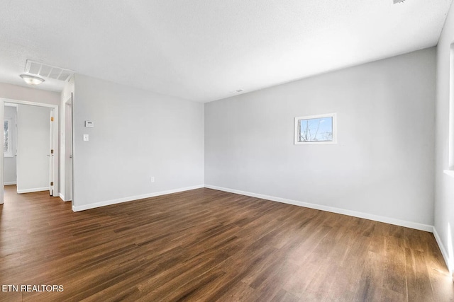 unfurnished room with dark hardwood / wood-style floors