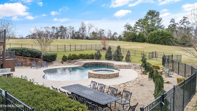 view of swimming pool with an in ground hot tub, a lawn, a patio, and a rural view