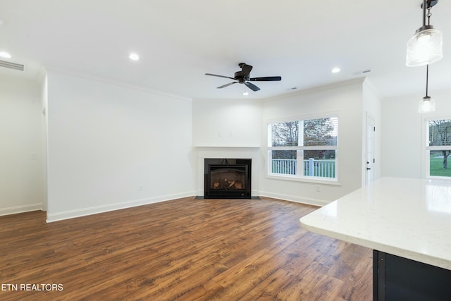 unfurnished living room featuring a fireplace with flush hearth, dark wood-style flooring, visible vents, and plenty of natural light