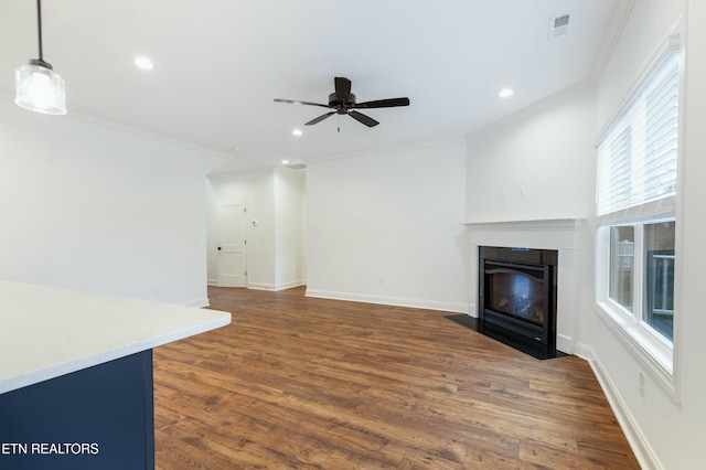 unfurnished living room featuring baseboards, a fireplace with flush hearth, ornamental molding, and dark wood-type flooring