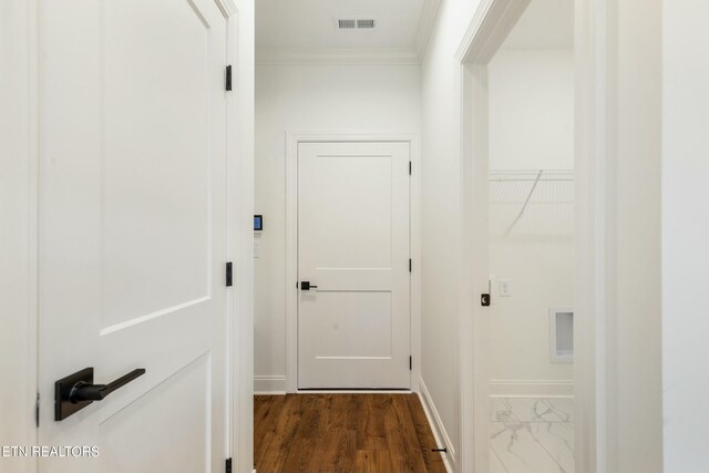 hall with ornamental molding, marble finish floor, visible vents, and baseboards