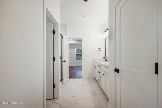 bathroom featuring marble finish floor, recessed lighting, vanity, and baseboards