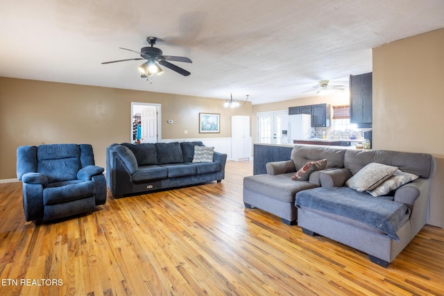 437 County Road 267, Niota, TN 37826 - living room featuring light wood-style flooring and ceiling fan with notable chandelier