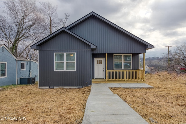 view of front of property with covered porch, central AC unit, crawl space, and board and batten siding