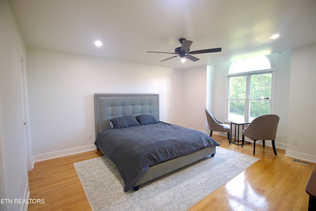 bedroom with light wood-type flooring, baseboards, recessed lighting, and a ceiling fan