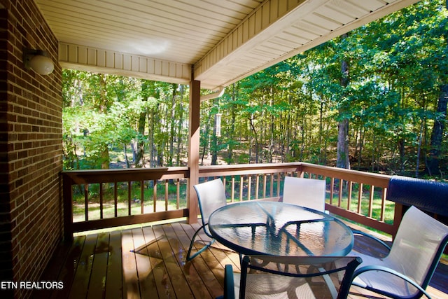 wooden deck featuring outdoor dining area