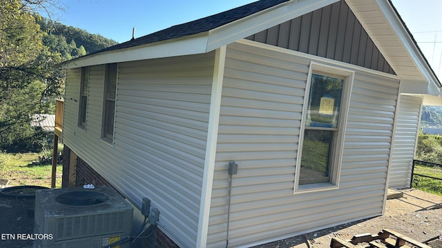 view of side of home with central AC unit