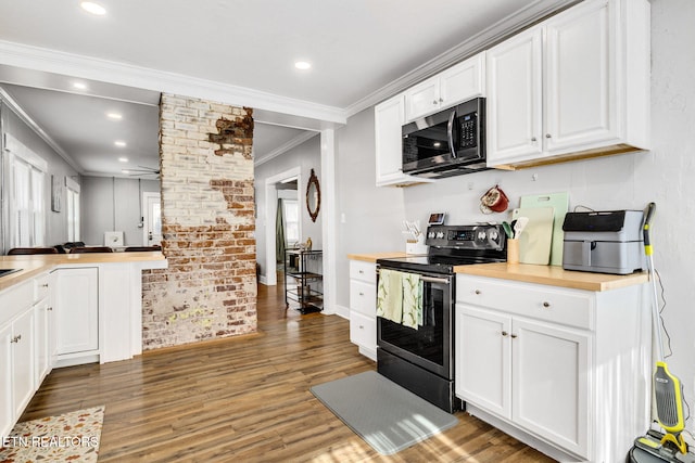 kitchen featuring crown molding, stainless steel appliances, dark wood-type flooring, and white cabinets