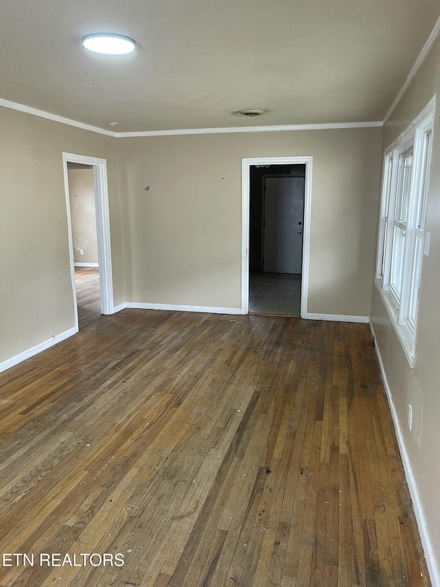 unfurnished room featuring crown molding and dark wood-type flooring