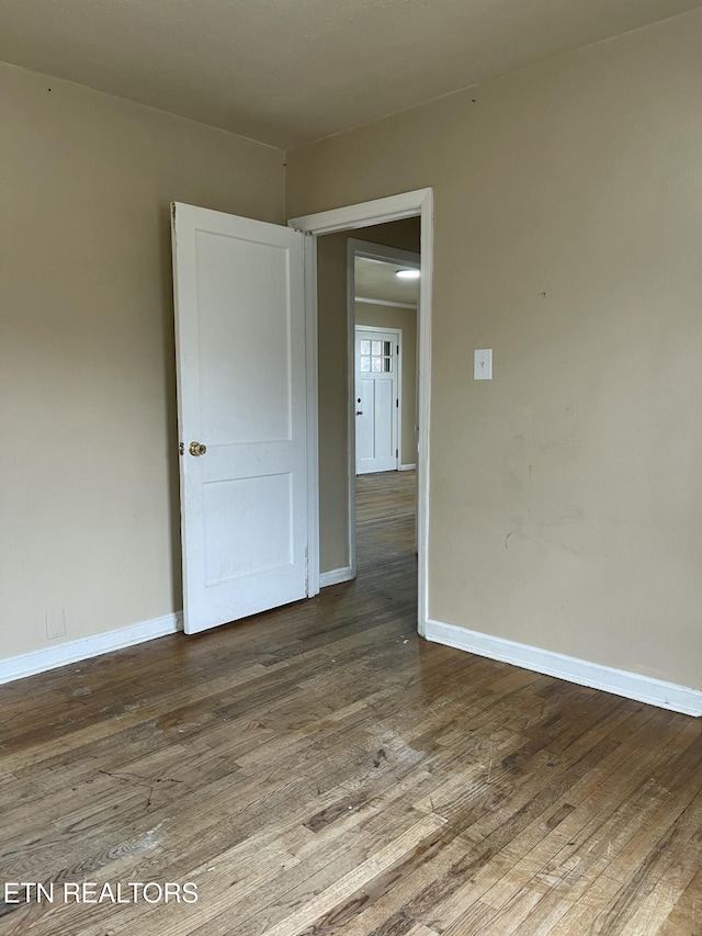 unfurnished room with hardwood / wood-style flooring