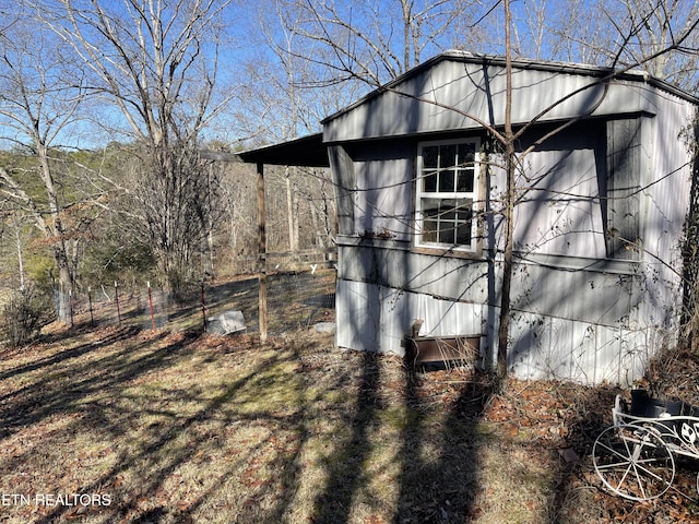 view of side of home featuring an outbuilding