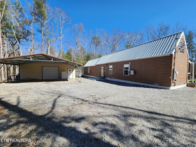 view of property exterior with an outbuilding, a carport, and a garage