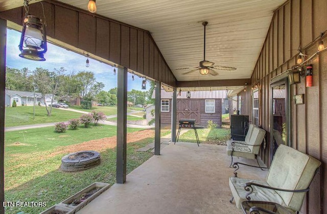 view of patio with ceiling fan and an outdoor fire pit