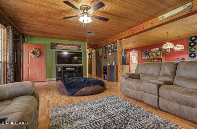 living room with hardwood / wood-style flooring, ceiling fan, and wooden ceiling