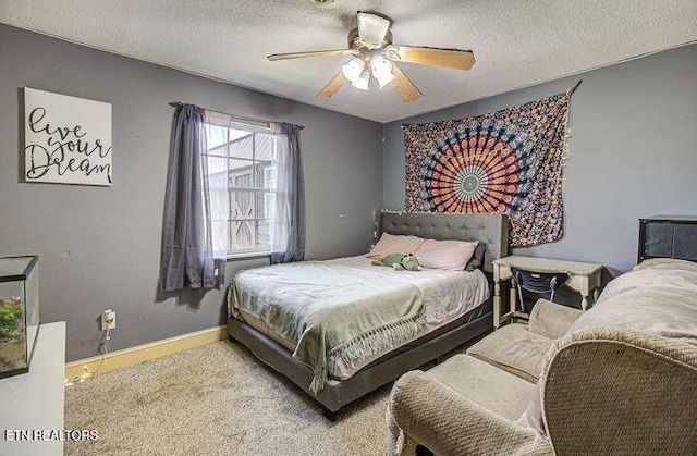 bedroom featuring ceiling fan, carpet floors, and a textured ceiling