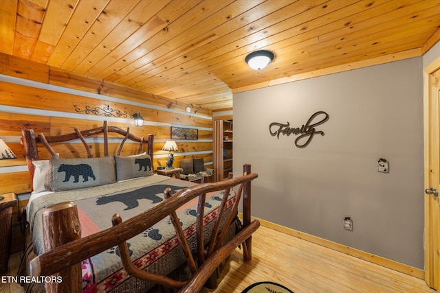 bedroom with wood-type flooring and wooden ceiling