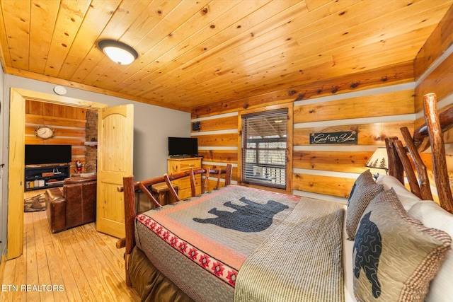 bedroom with wooden walls, light hardwood / wood-style flooring, and wooden ceiling