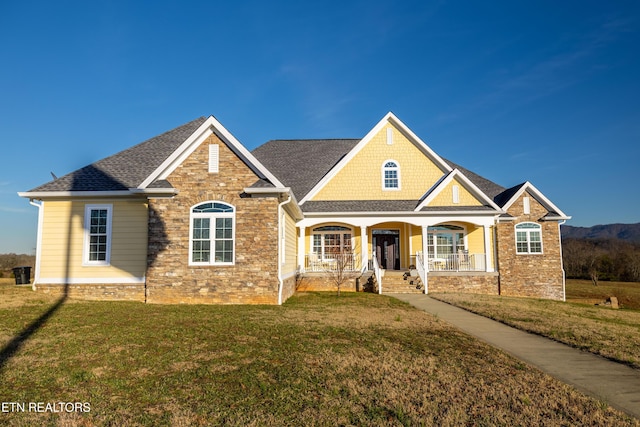 craftsman-style home with a front lawn and a porch