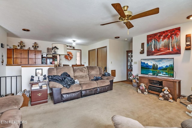 living room featuring carpet floors and ceiling fan