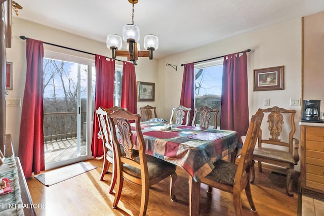 dining room with an inviting chandelier and light wood-type flooring