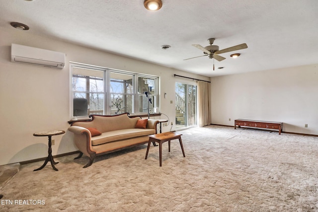 living room featuring ceiling fan, a wall unit AC, a textured ceiling, and carpet