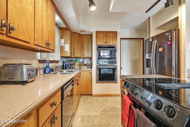 kitchen featuring sink, light tile patterned floors, and black appliances