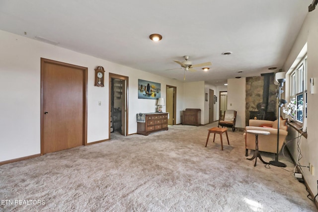 interior space with carpet flooring and ceiling fan