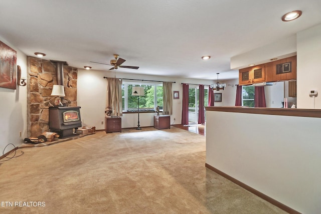 27 Brambleton Ct, Crossville, TN 38558 - unfurnished living room featuring a wood stove, light colored carpet, a chandelier, ceiling fan, and recessed lighting
