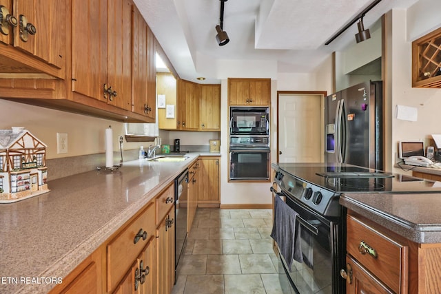 27 Brambleton Ct, Crossville, TN 38558 - kitchen with black appliances, rail lighting, brown cabinets, and light tile patterned flooring