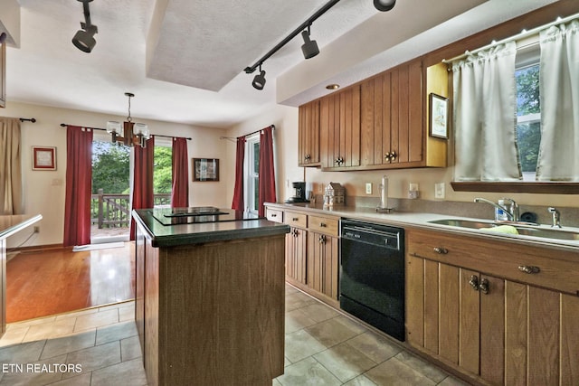27 Brambleton Ct, Crossville, TN 38558 - kitchen featuring black appliances, rail lighting, a center island, a chandelier, and brown cabinetry